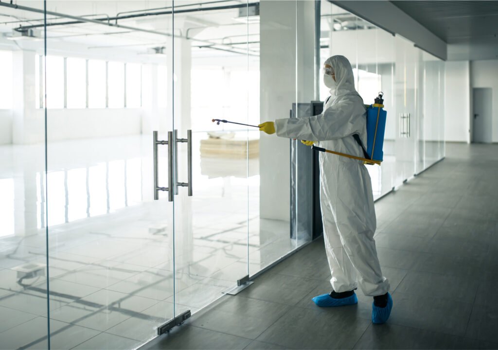 IPM Tech Pest Control Services worker Sanitizing an office building